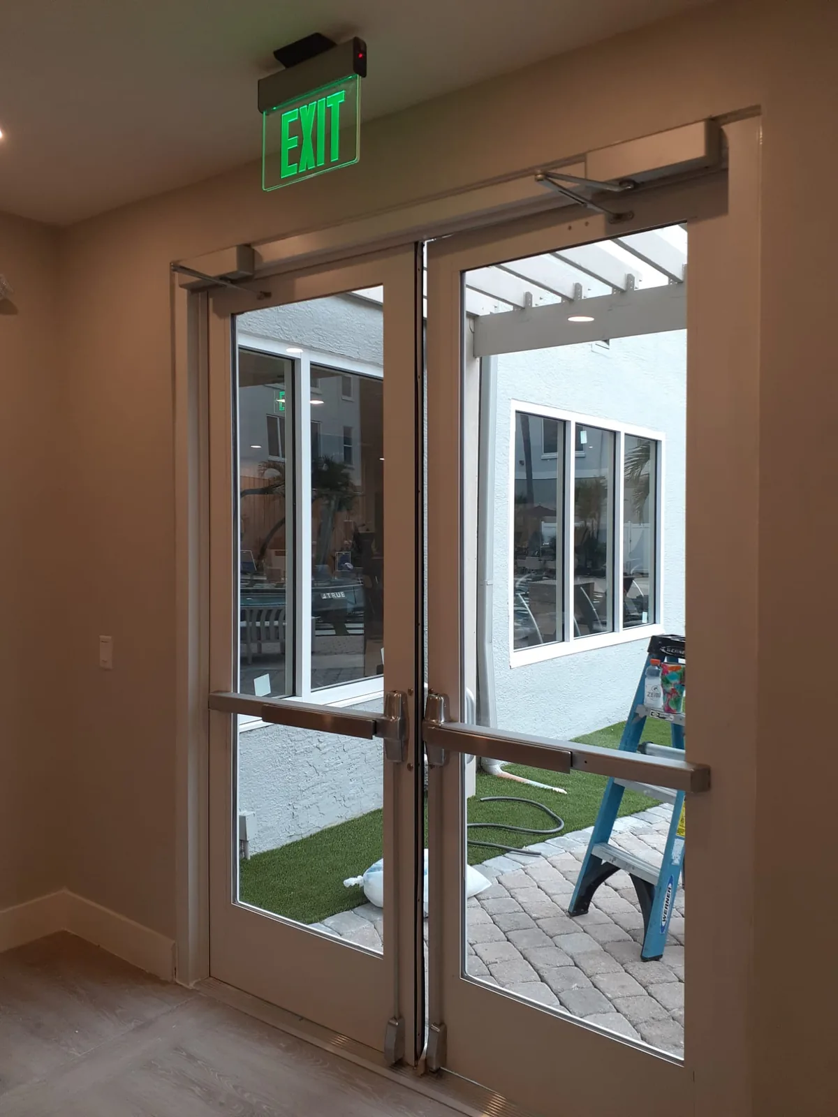 Double glass entry doors with closers and panic hardware