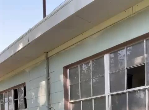 The Tampa motel before the project: original multi-lite windows, several panes broken or missing